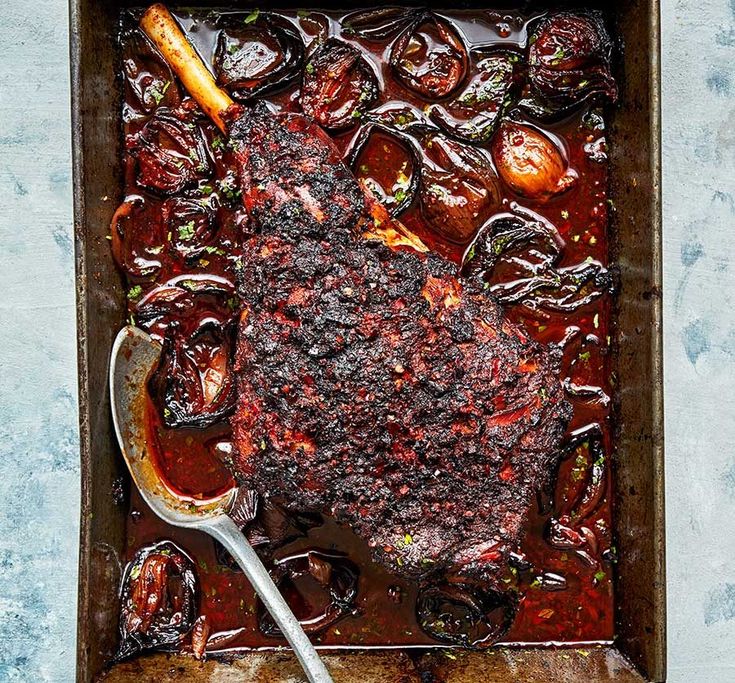 a roasting pan filled with meat and vegetables