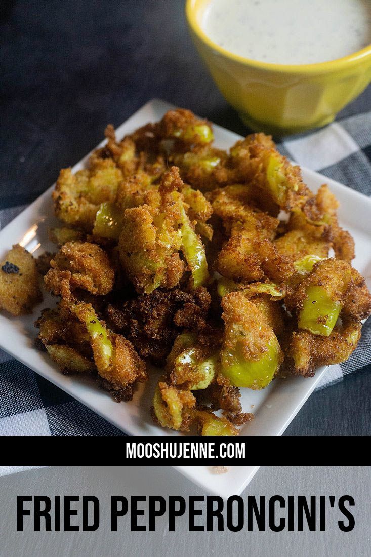 fried pepperoni's on a white plate next to a cup of ranch dressing