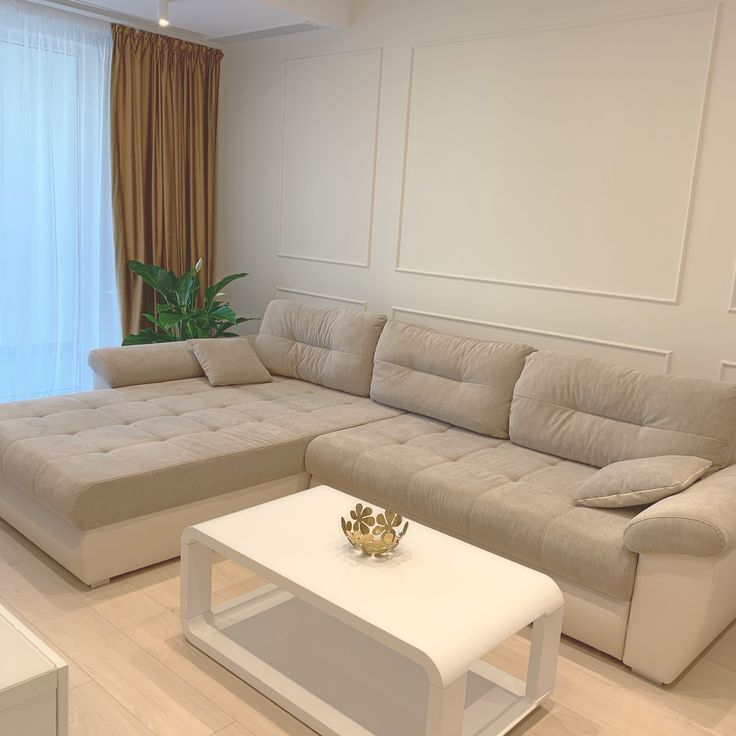 a living room filled with furniture and a white coffee table