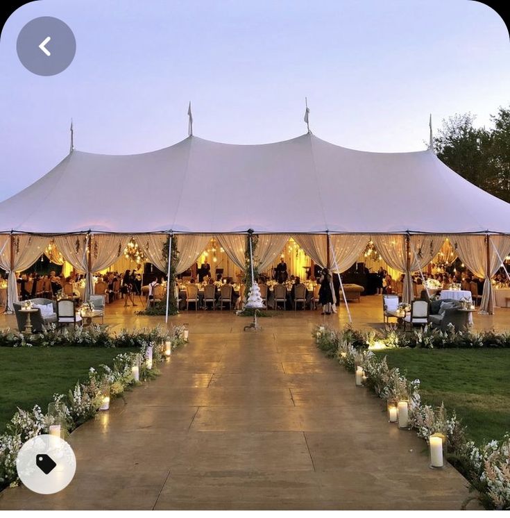 a large tent set up with candles and flowers