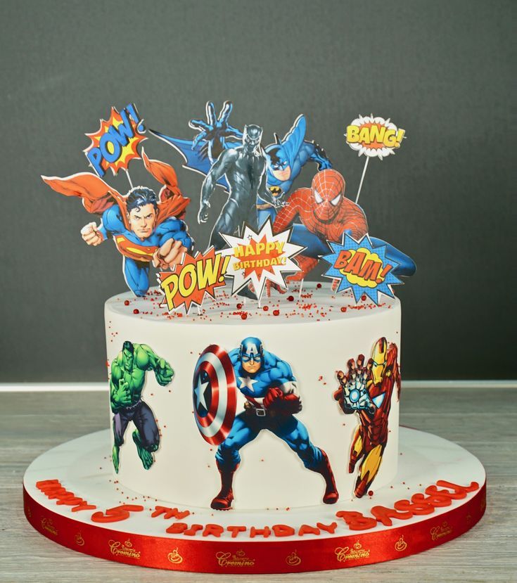 a birthday cake decorated with superheros and stars