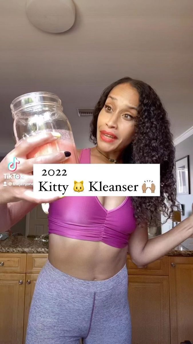 a woman holding up a jar filled with liquid in her right hand and the words kitty klemser on it