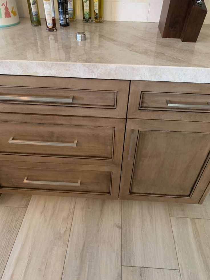 an image of a kitchen setting with marble counter tops and wooden cabinets in the background