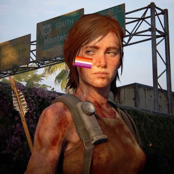 a woman with blood on her face holding a flag in front of a street sign