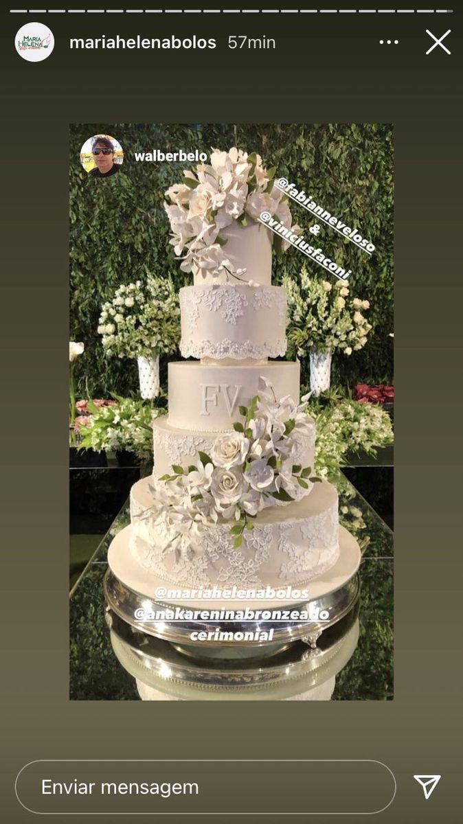 a three tiered cake with flowers on the top is displayed in an instagramtion