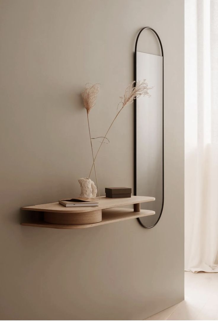 a mirror and shelf in a white room