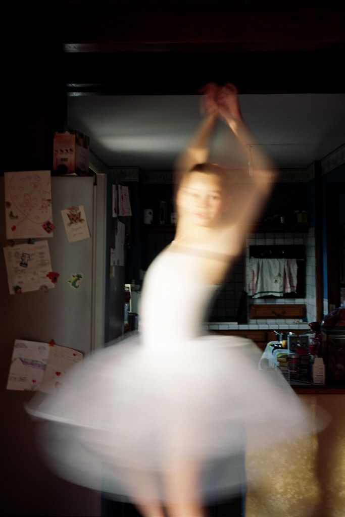 a woman in a white dress is dancing