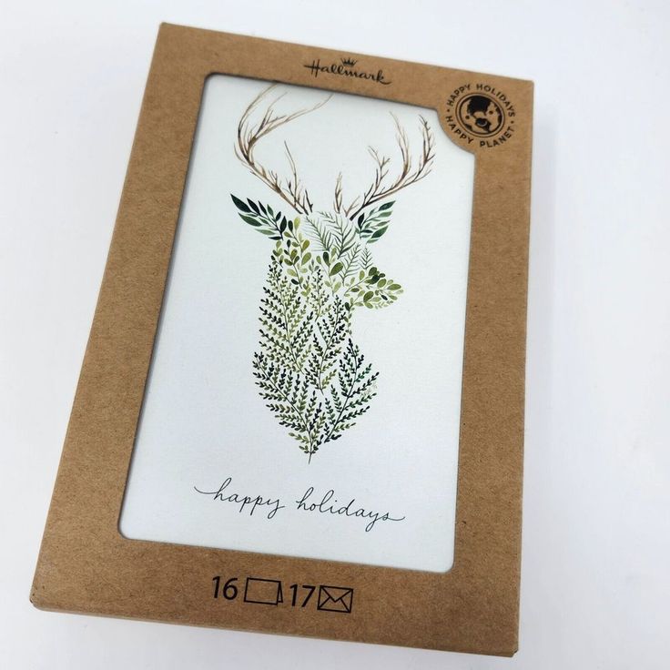 a card with an image of a deer's head on it in a cardboard box