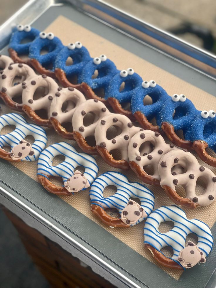 an assortment of decorated donuts on a tray