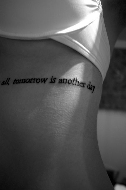 a woman's back with the words all tomorrow is another day written on it