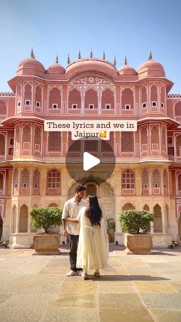 a man and woman standing in front of a pink building with the words those lyrics and we in jajabiu written on it