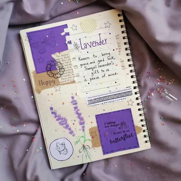 an open notebook sitting on top of a bed covered in confetti