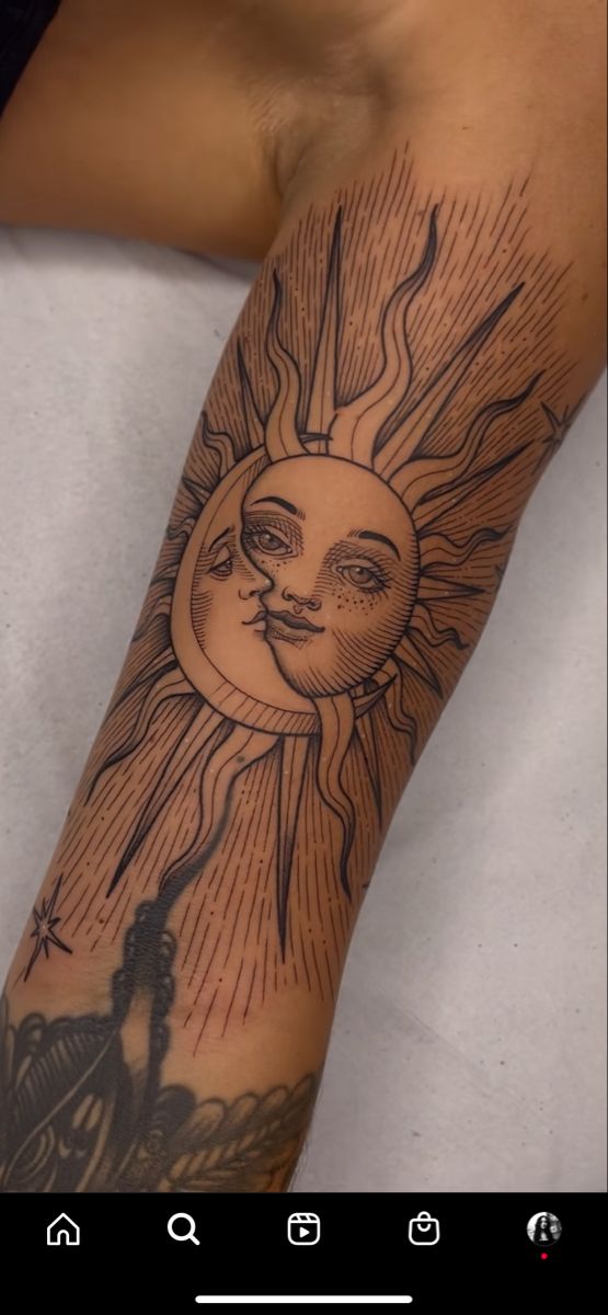 a person with a sun tattoo on their arm