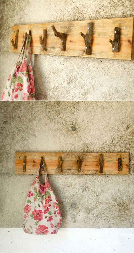 two wooden coat racks with hooks on them and one has a flowered bag hanging from it