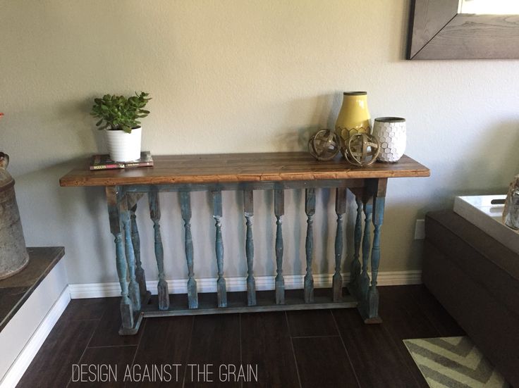 a wooden table sitting in the corner of a room