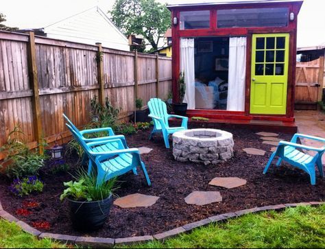 a backyard with chairs and a fire pit