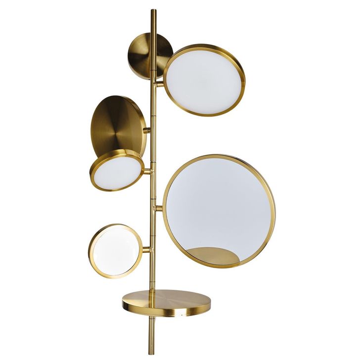 three round mirrors on a metal pole with two circular mirrors hanging from it's sides