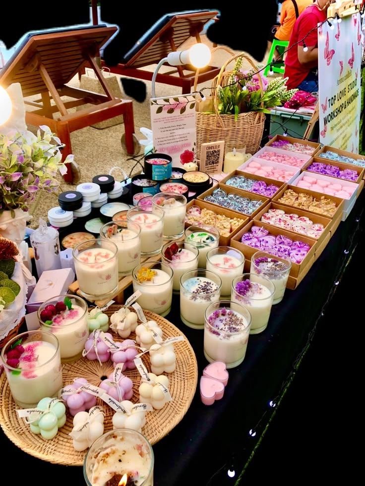 a table filled with lots of desserts and candles on it's display stand