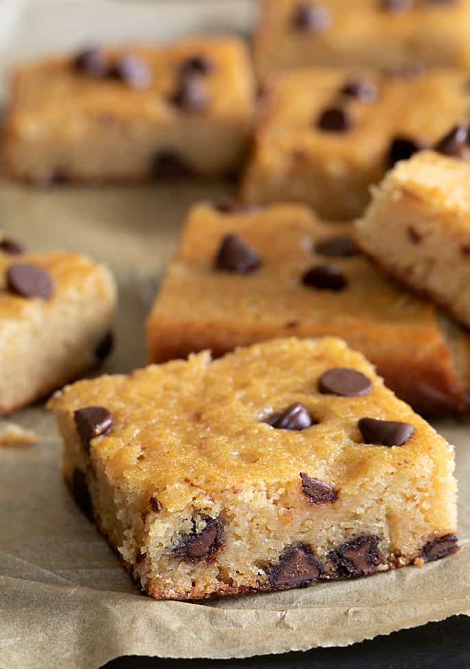 chocolate chip cookie bars sitting on top of parchment paper