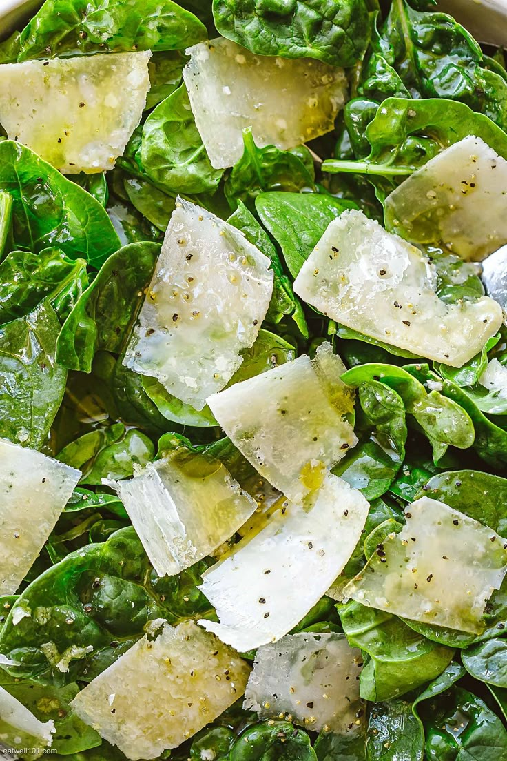 spinach salad with parmesan cheese in a bowl