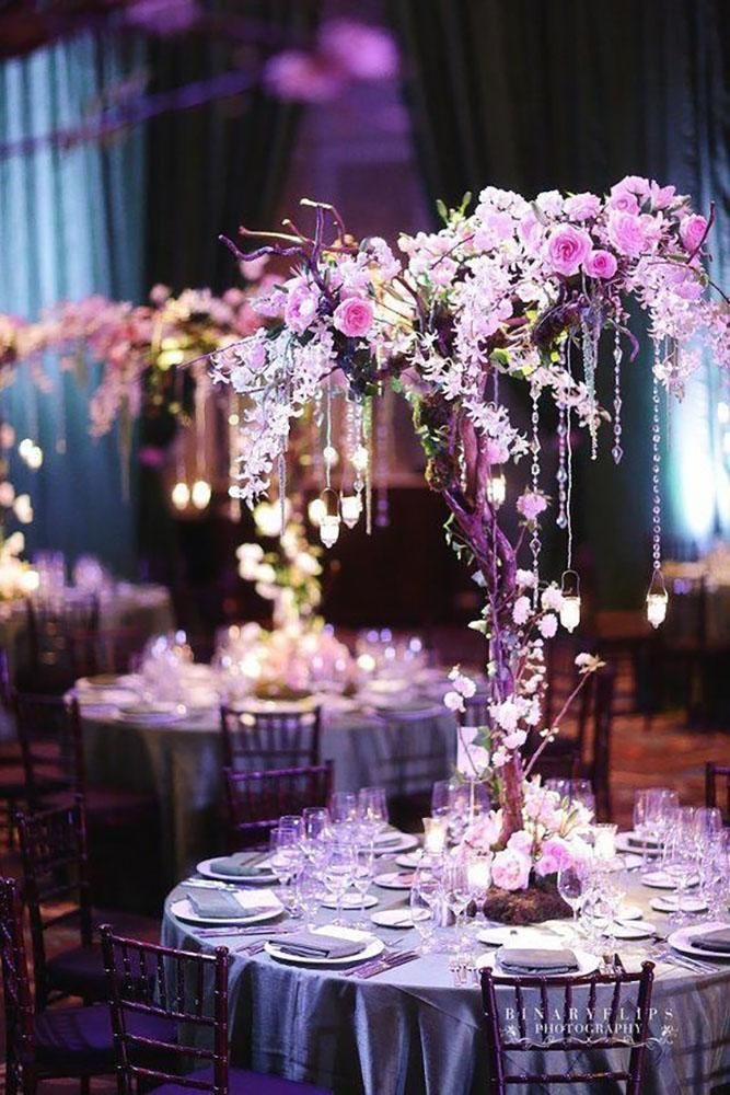 the tables are decorated with purple and white flowers