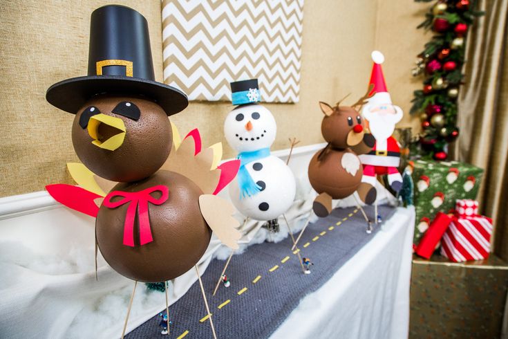 some paper mache turkeys and snowmen on a table