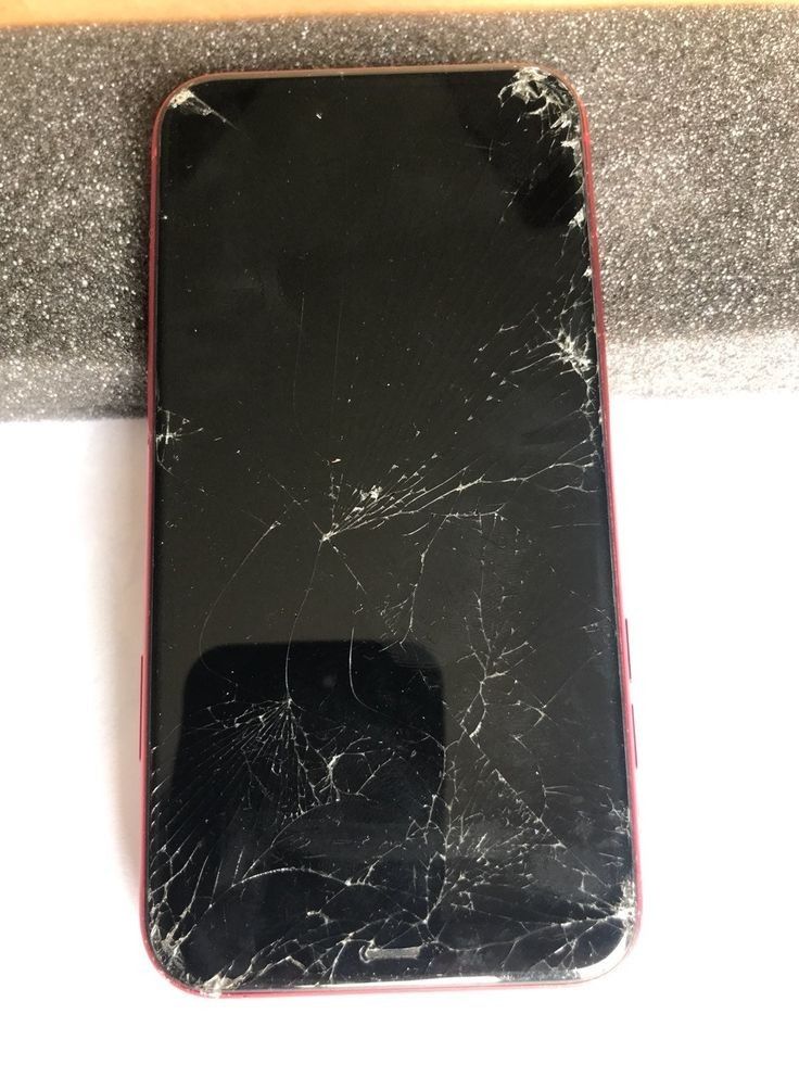 a broken cell phone sitting on top of a counter