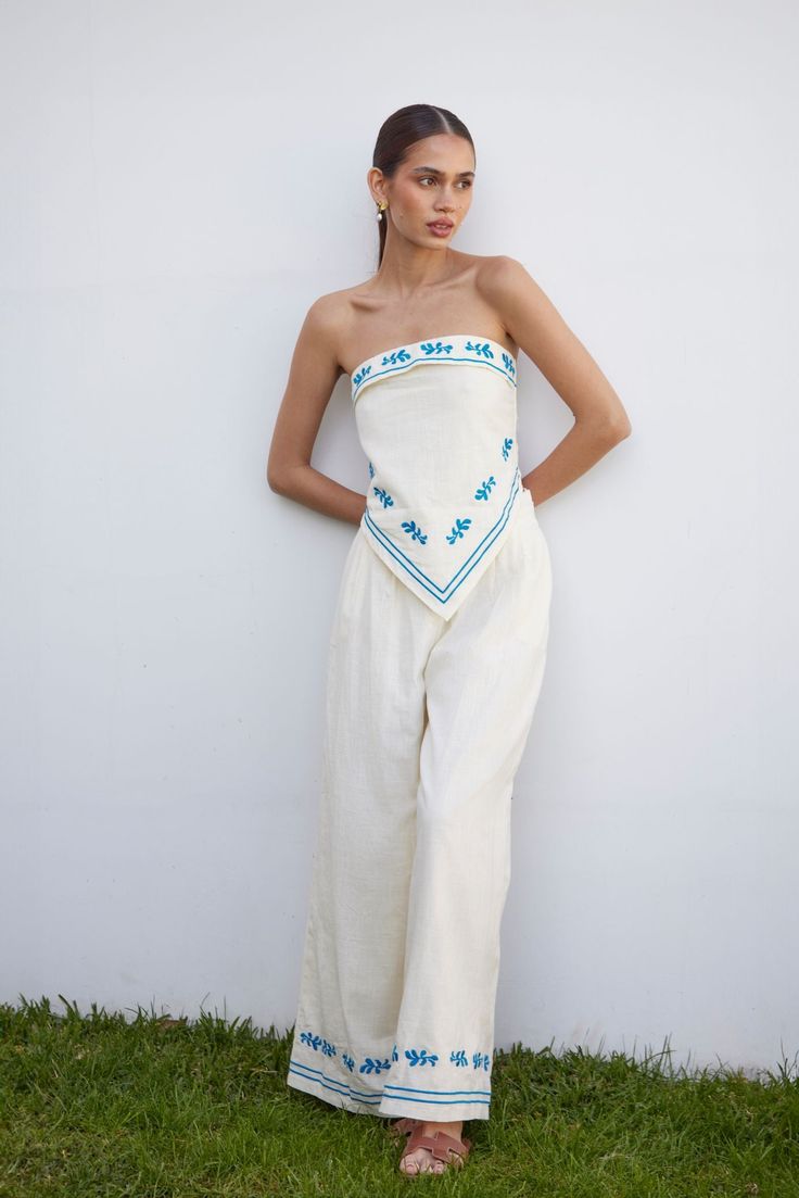 Step into effortless grace with the Serene Two-Piece Set's wide-leg pants. Adorned with delicate blue floral embroidery, these pants combine comfort and sophistication, making them perfect for any occasion. The high waist and elastic waistband offer a comfortable yet chic fit, while the flowy silhouette ensures you stay stylish and cool all summer long. LS204 Italy Looks Summer, Preppy Italy Outfits, El Salvador Outfits, Summer Greece Outfit, Outfits For Spain Summer, Clothes For Italy, Cruise Attire For Women, Cruise Pics Ideas, Anthropology Clothing