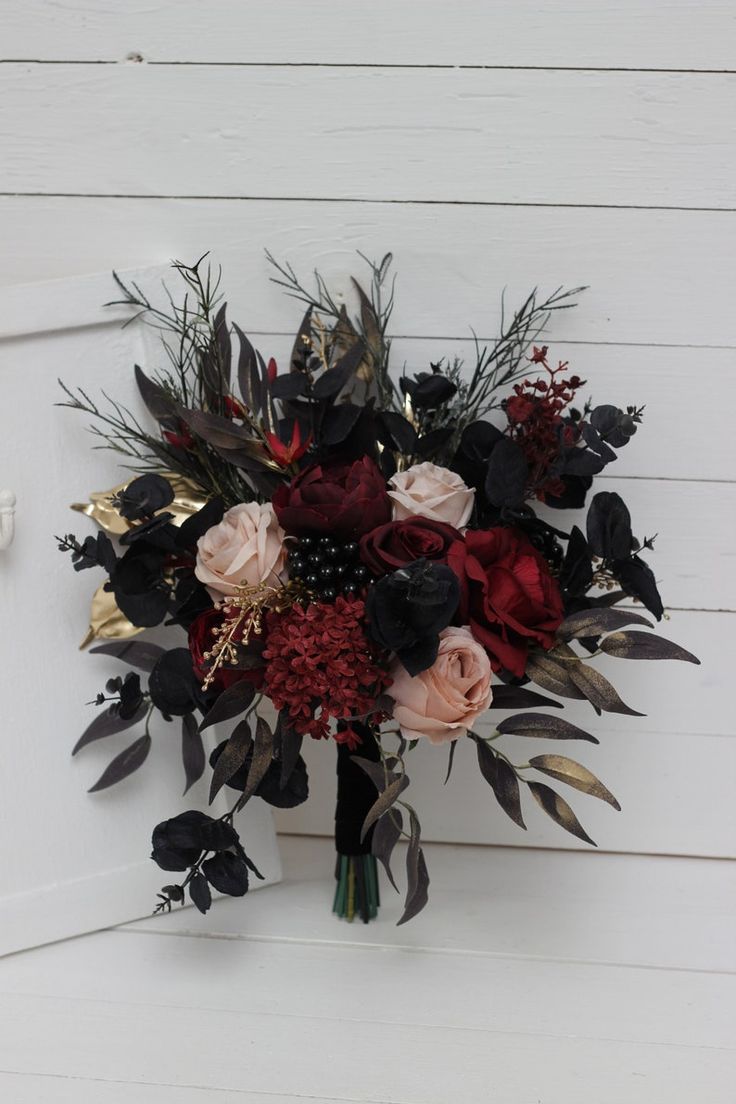 a bouquet of flowers sitting on top of a white door