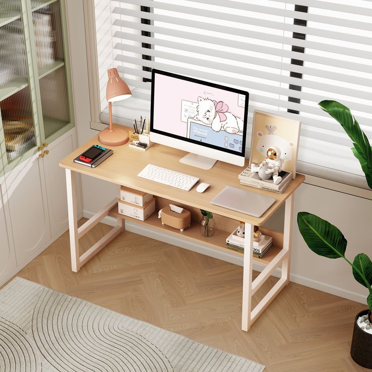 a wooden desk with a computer on top of it next to a potted plant