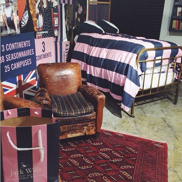 there is a bed, chair and other items on display