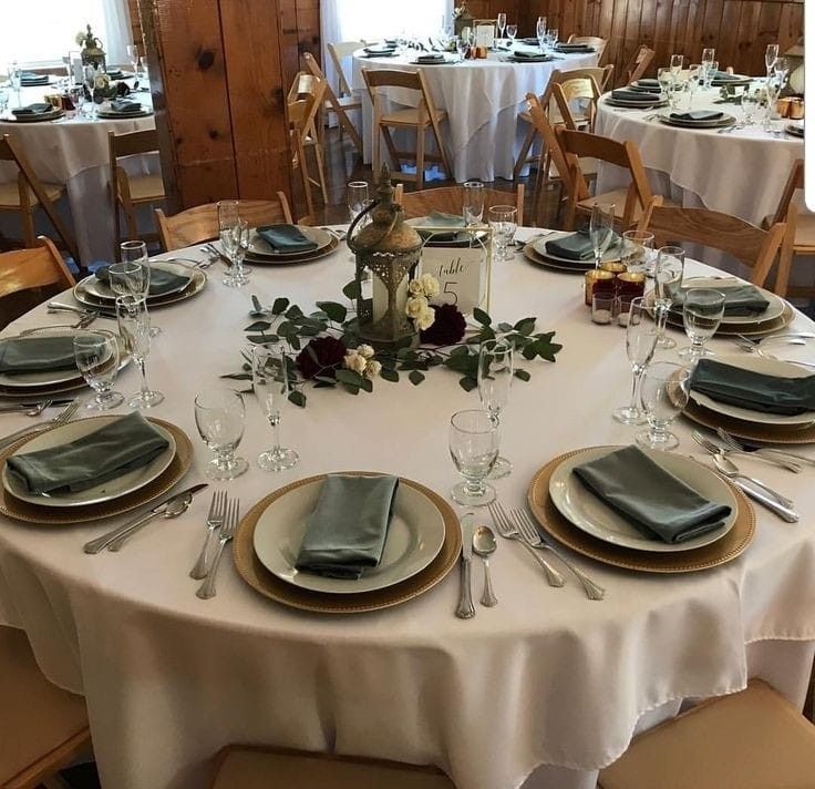 the table is set with silverware and place settings