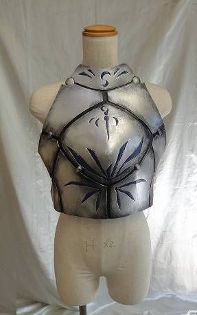 a white mannequin with black and silver designs on it's chest,