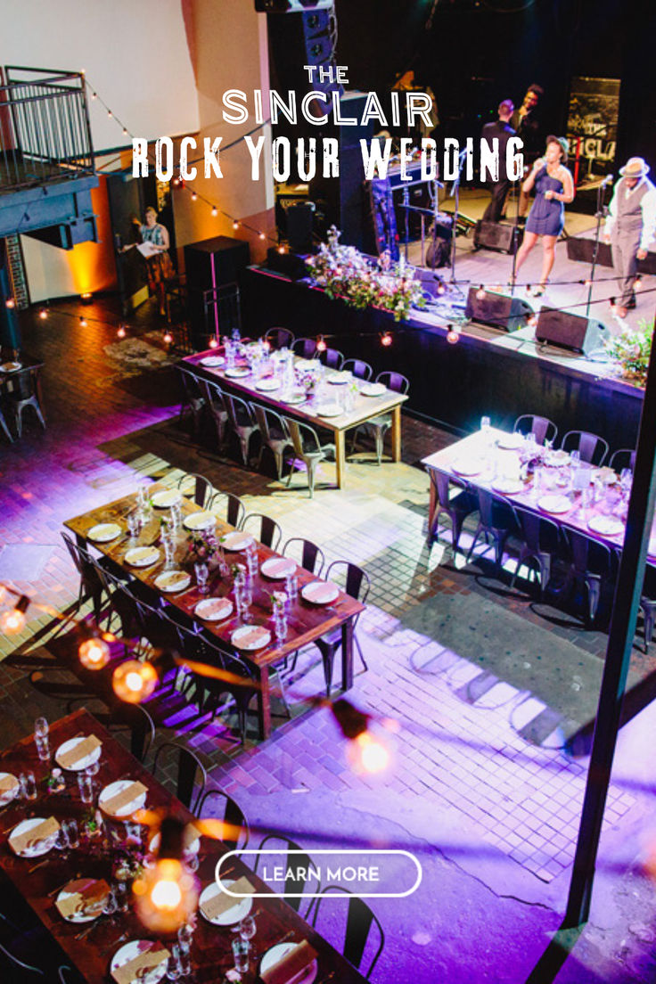 an indoor venue with tables and chairs set up for a wedding reception, surrounded by candles