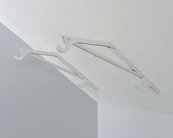 two white clothes hangers attached to the ceiling