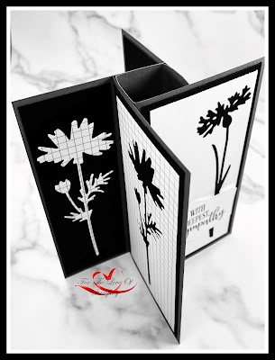 an open card with black and white flowers on it