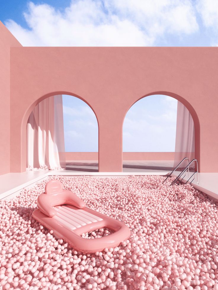 an inflatable chair sitting on top of a gravel covered ground next to two archways