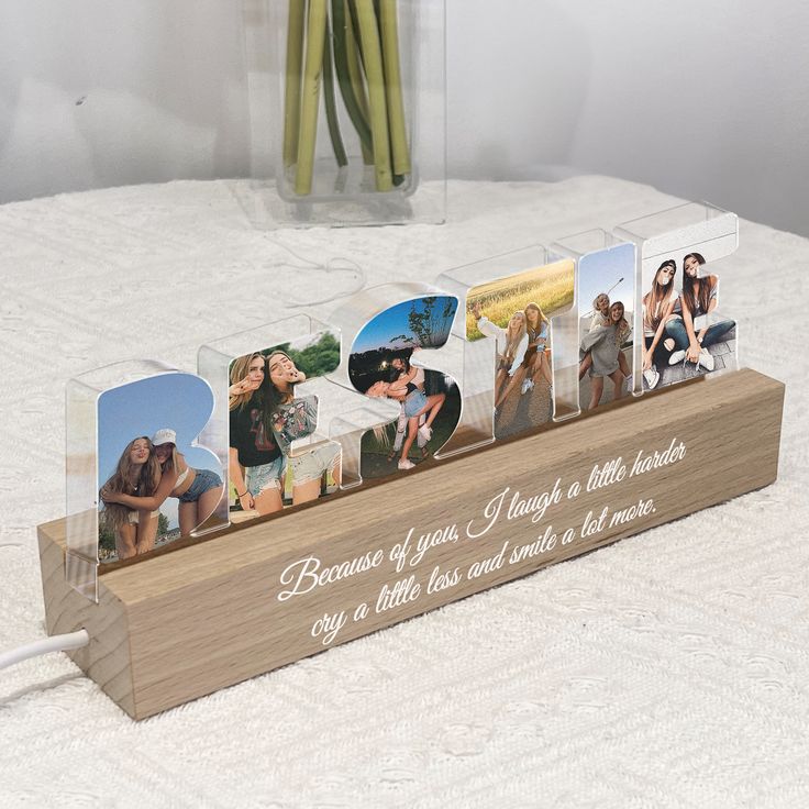 a wooden photo display with four pictures on it