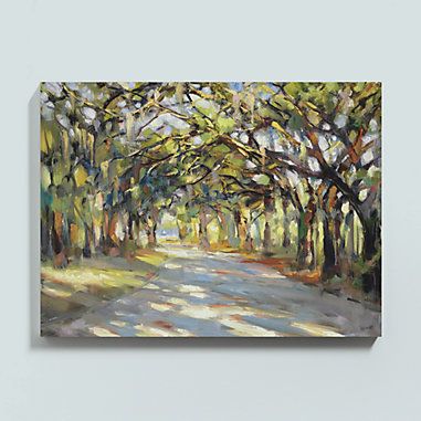 a painting hanging on the wall in front of a gray wall with trees and grass