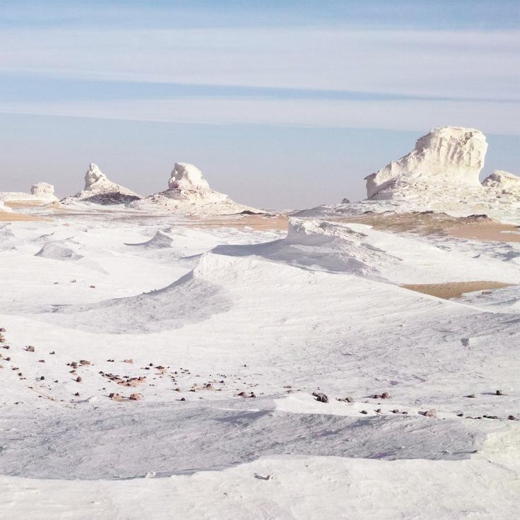 snow covered hills and rocks in the distance