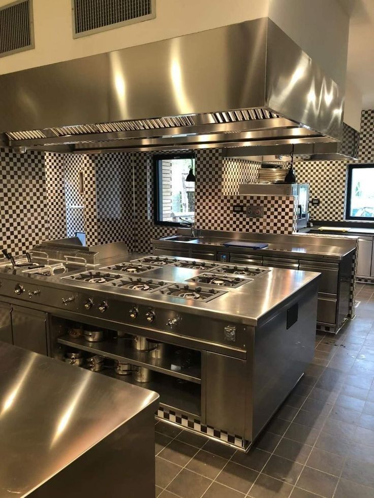 an industrial kitchen with stainless steel appliances and counters