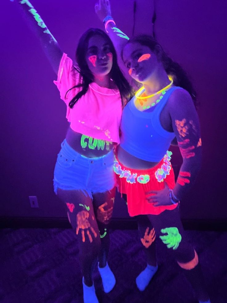 two girls in neon clothing posing for the camera