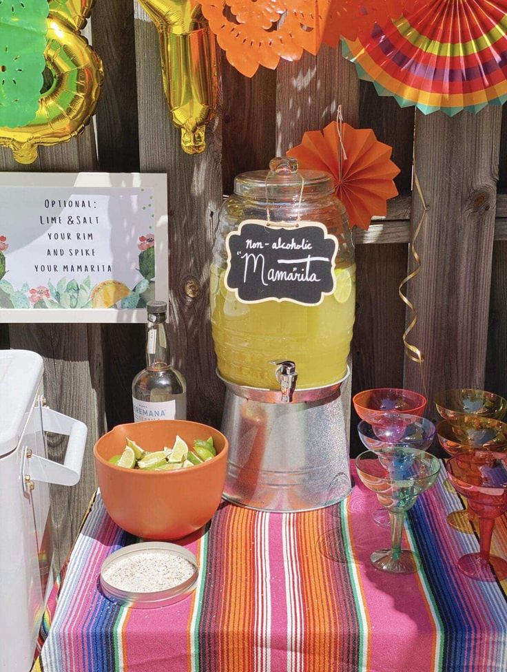 a table topped with lots of different types of food and drinks next to paper fans