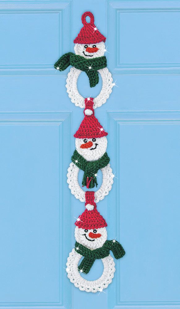 three snowman wreaths hanging on the front door