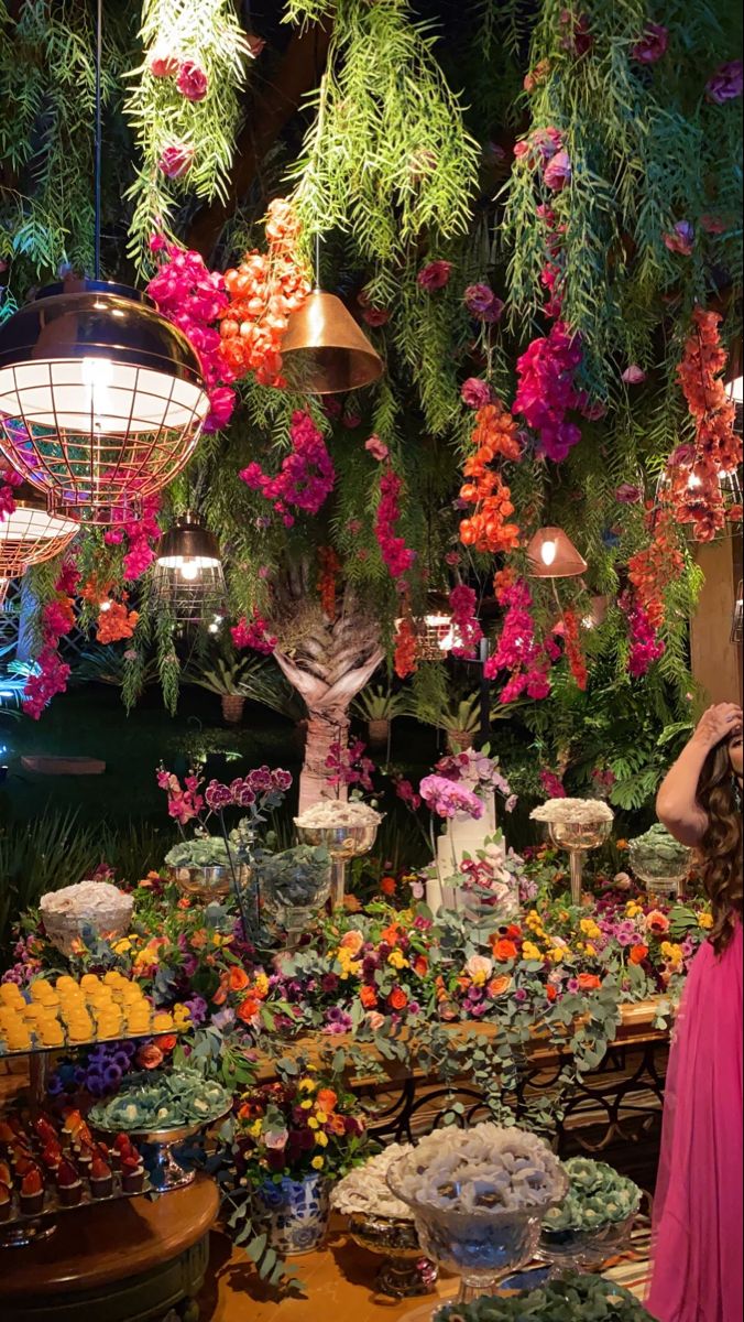 a woman standing in front of a display of flowers