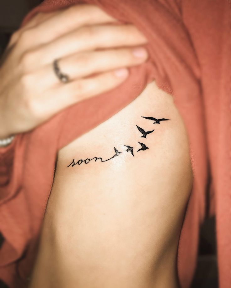 a woman's arm with three birds on it and the word moon written in black ink