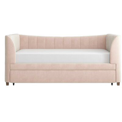 a pink couch with white sheets and pillows on it's back end, against a white background