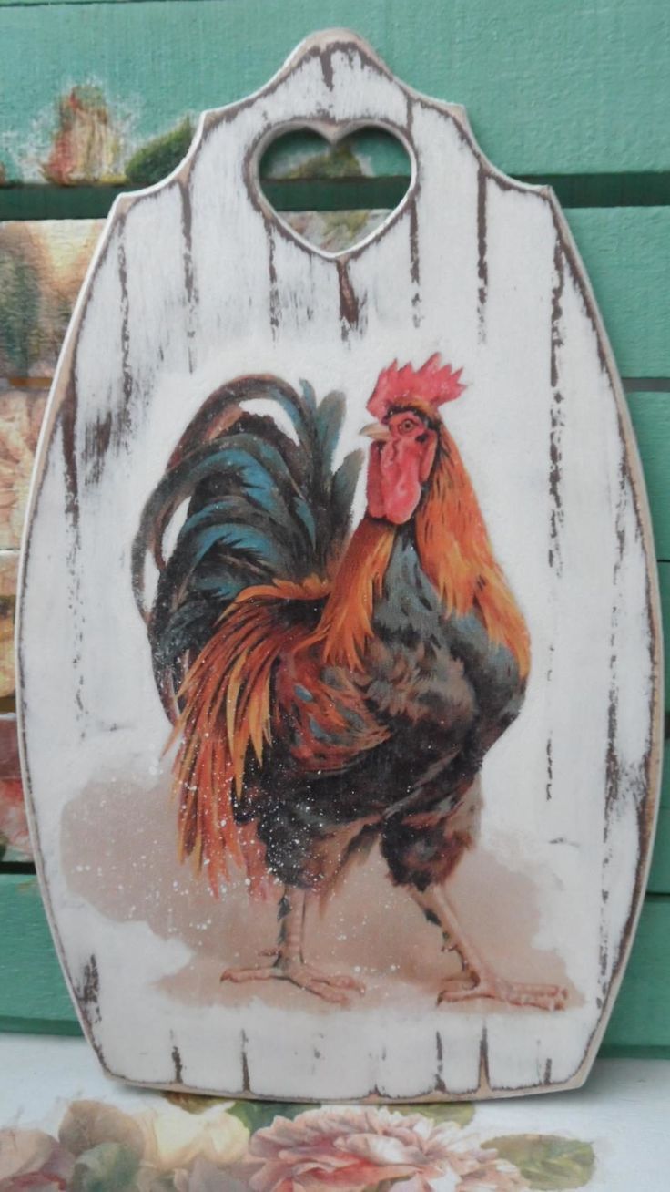 a rooster painted on the side of a wooden sign