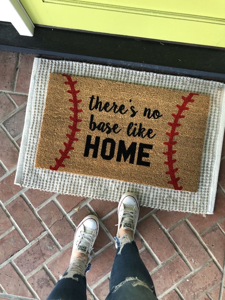 someone is standing in front of a door mat that says, there's no base like home