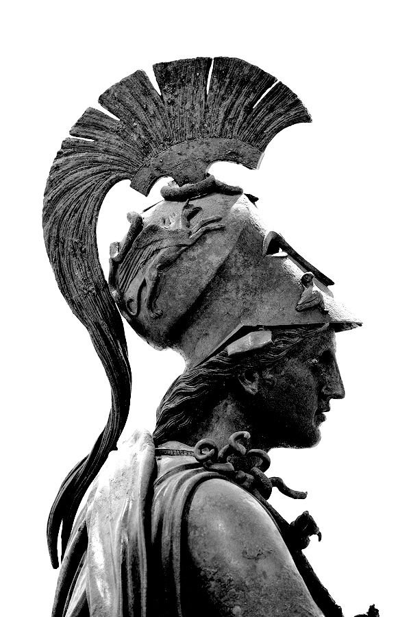 black and white photograph of a statue with feathers on it's head, looking up at the sky